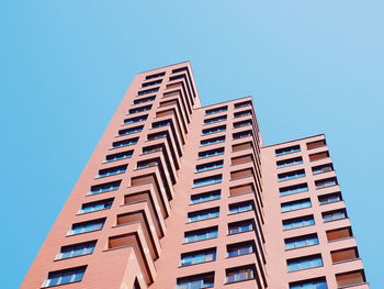 Low angle view of modern building against clear blue sky