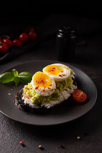 Breakfast with avocado toast with eggs on a plate