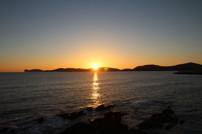 Scenic view of sea against clear sky during sunset