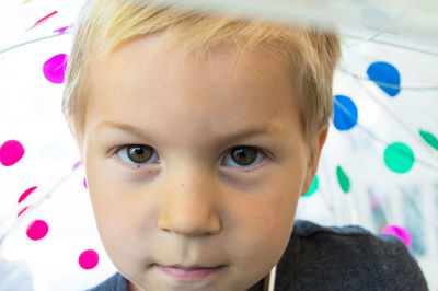 Close-up portrait of boy with umbrella