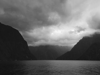 Scenic view of sea and mountains against sky