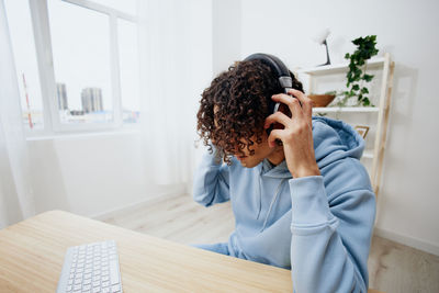 Young man wearing headphones at office