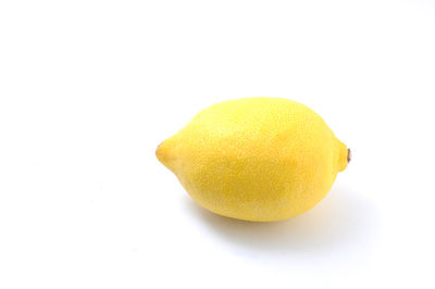 Close-up of yellow fruit against white background