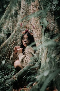 Portrait of young woman in forest