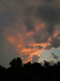 Low angle view of silhouette trees against sky during sunset