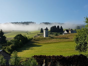 Scenic view of field against cloudy sky