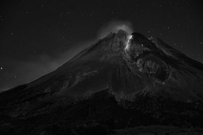 Scenic view of snowcapped mountains against sky at night