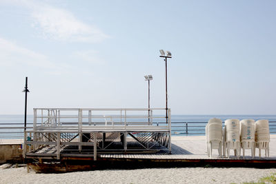 Ship moored on beach against sky