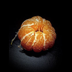 High angle view of orange slices over black background