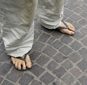 Low section of person standing on footpath