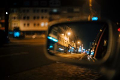 Cars on illuminated street at night