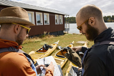 Men checking map before kayak trip