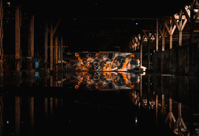 Reflection of illuminated building in water at night