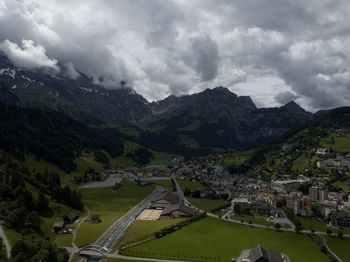 Aerial view of buildings and mountains against sky