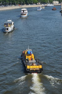 Boat sailing on river in city