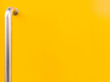 Close-up of handle on yellow door