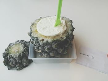 Close-up of cake on table against white background