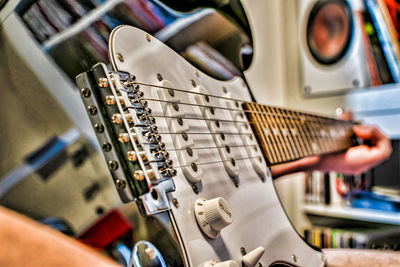 Cropped hand of person playing guitar