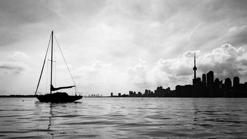 Ship sailing in sea against sky