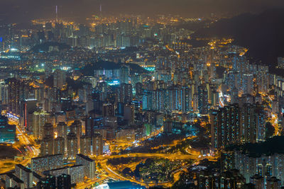 High angle view of illuminated city buildings at night