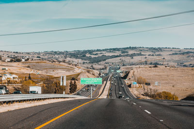 Road by mountain against sky