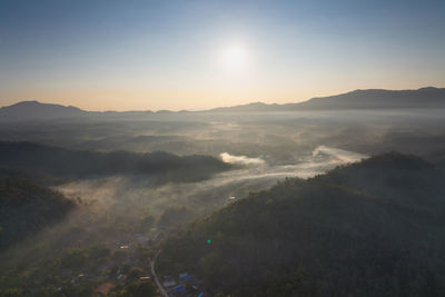 Aerial view of cityscape against sky during sunset