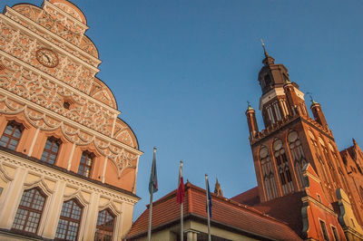 Low angle view of clock tower against blue sky