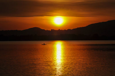 Scenic view of sea against orange sky