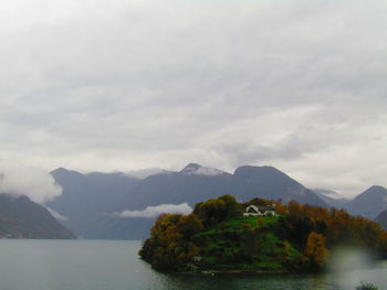 Scenic view of sea and mountains against sky