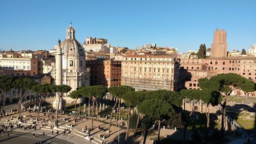 View of cityscape against clear blue sky