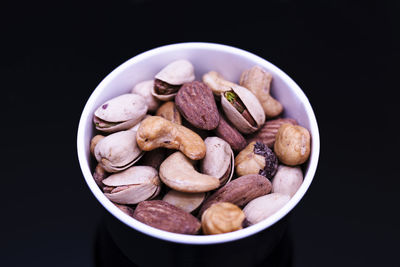 Close-up of food in bowl on table against black background