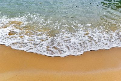 High angle view of waves rushing towards shore