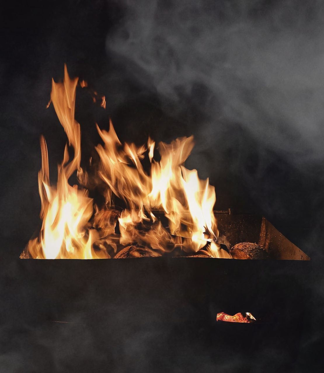 CLOSE-UP OF BURNING FIRE IN THE DARK