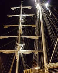 Low angle view of illuminated ferris wheel against sky at night