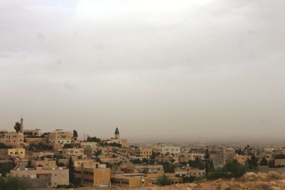 High angle view of buildings in city against sky