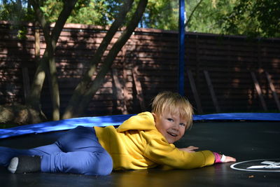 A boy on a trampoline in the garden.