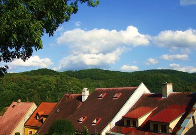 House on mountain against cloudy sky