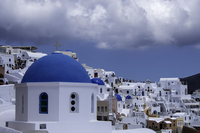 Santorini, greece, may 5, 2024. traditional village houses with blue dome