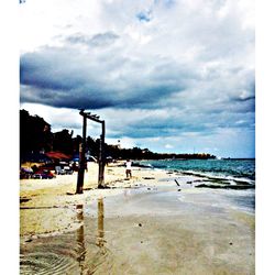 Scenic view of sea against cloudy sky