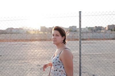 Young woman standing against clear sky