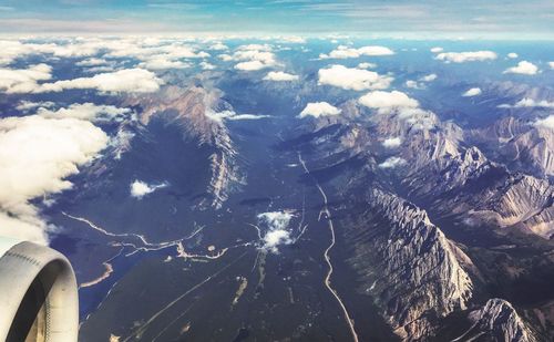 Aerial view of land and sea against sky