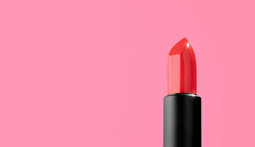 Close-up of red lipstick against yellow background