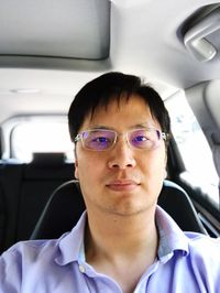 Portrait of man sitting in car