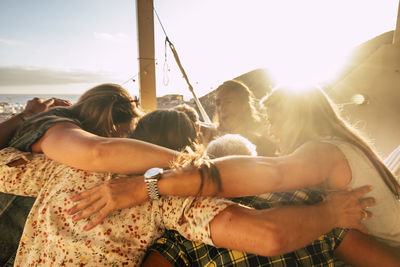 Group of people huddling at home during sunset