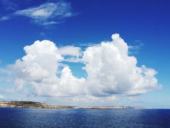 Scenic view of sea against blue sky