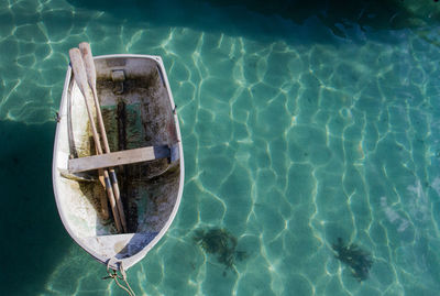 High angle view of rowboat with oars moored in sea