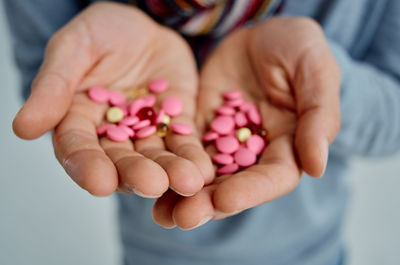 Close-up of hand holding pink flower