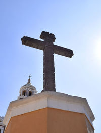 Low angle view of cross against clear sky