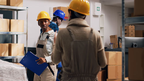 Rear view of man standing in factory