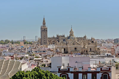 View of buildings in city against clear sky